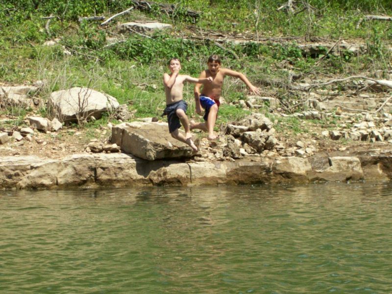 Boys jumping into the lake